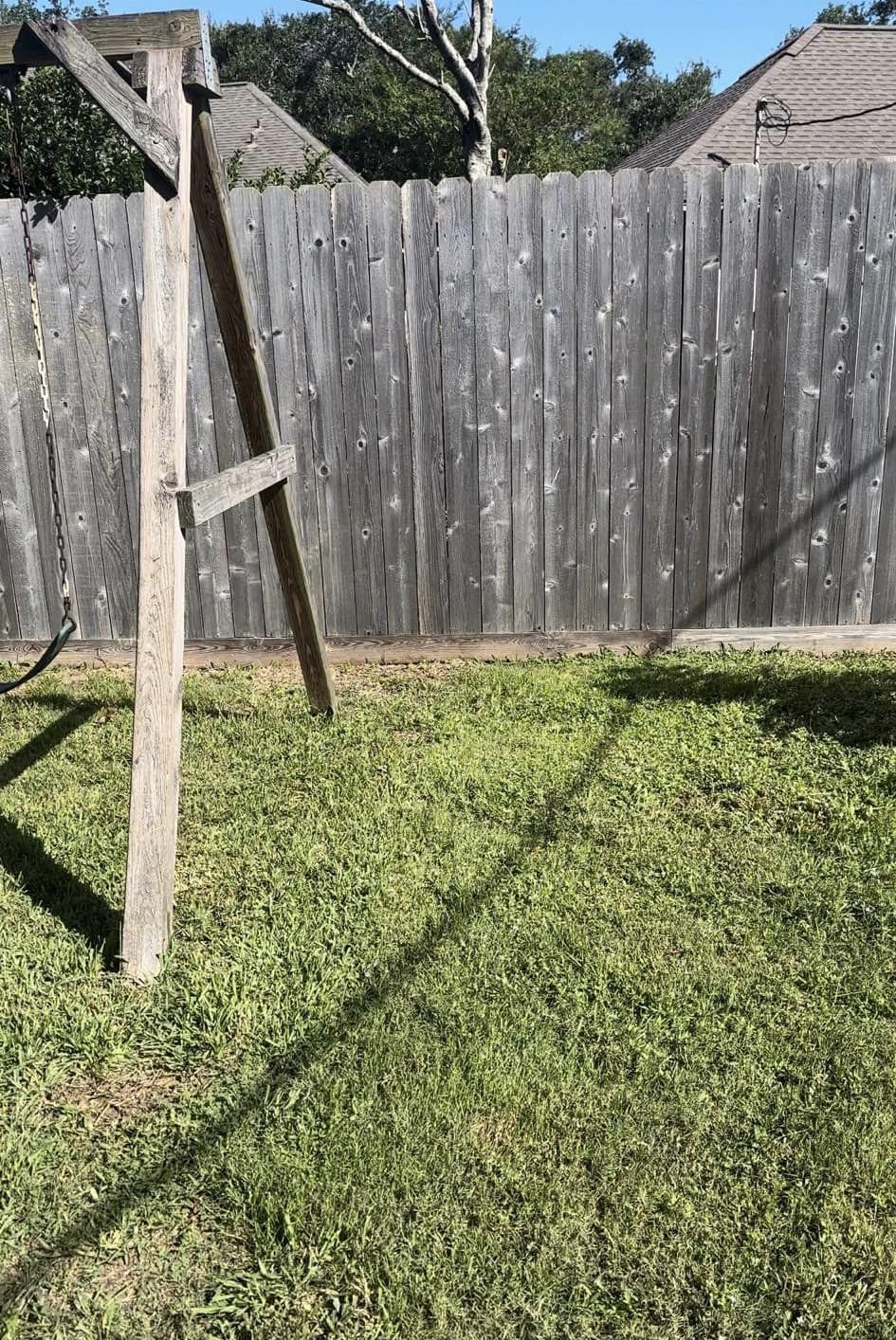 Before: A weathered gray fence before cleaning and the same fence after, showing restored wood color